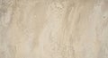 Beige textured wall with irregular patterns and subtle color variations. The surface displays faint Royalty Free Stock Photo