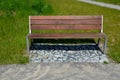 Beige threshing path gravel with delimited edges granite cubes in a row and dividing channels from the cube trough channel due to