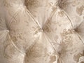 Beige velour upholstery with a button-down background for luxurious decoration.
