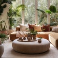 Beige velvet sofa with terra cotta cushions between houseplants. Wooden round coffee table near ottoman on knitted rug