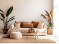 Beige velvet sofa with terra cotta cushions between houseplants. Wooden round coffee table near ottoman on knitted rug.