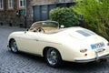 beige vintage porsche 356 Cabriolet, Retro luxury sports car which was first produced by Austrian company Porsche parked on street