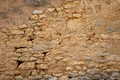 Beige wall pebble stones old weathered handcrafted stone wall background