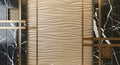 Beige wave texture panel with black marble and gold trim Royalty Free Stock Photo