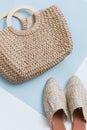 Beige wicker bag and mules on a pastel background. Wicker basket and shoes top view. trendy and stylish accessories. Trend 2019 Royalty Free Stock Photo