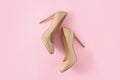 Beige women high heel shoes on pink background. Fashion blog look. Top view, flat lay.