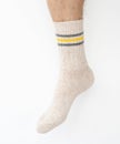 Beige woolen sock on a man`s leg