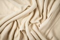 Beige woven textile drape background. Waving cloth fabric canvas