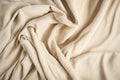 Beige woven textile drape background. Waving cloth fabric canvas