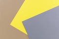 Beige, yellow and gray colored paper. Geometric empty paper background of three tones, copy space Royalty Free Stock Photo