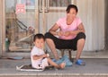 Woman with child in front of their house, Beijing, China