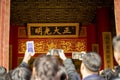 Beijing, China, January 2, 2020 : Tourist crowd take vedeo ancient dragon throne of the Emperor of China at Qianqinggong Palace