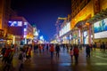BEIJING, CHINA - 29 JANUARY, 2017: Walking on the famous pedestrian shopping street Wangfujing on a dark evening, busy Royalty Free Stock Photo