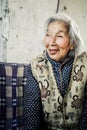 Elderly chinese grandmother relaxing in the garden