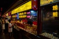 Chinese people buying sweets from a street confectionery at night. Snack street food market Beijing china Royalty Free Stock Photo