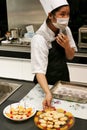 Beijing China - June 10, 2018: A female chef treats visitors with ready-made cookies, beautifully served on plates.