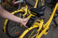 Person renting a bicycle with a mobile application. Urban transportation, eco friendly sustainable cities. Beijing China