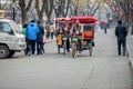 BEIJING, CHINA - MARCH 12, 2016: Tourists in a rickshaw in a hut Royalty Free Stock Photo