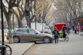 BEIJING, CHINA - MARCH 12, 2016: Tourists in a rickshaw in a hut Royalty Free Stock Photo