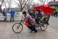 BEIJING, CHINA - MARCH 12, 2016: Tourists in a rickshaw in a hut Royalty Free Stock Photo