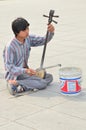 A beggar playing the erhu