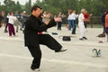 Group of senior people practice tai chi chuan gymnastics outdoors in Beijing, China.