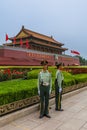 Beijing, China - May 16, 2018: Policeman near Mao Tse Tung Tiananmen Gate in Gugong Forbidden City Palace. Chinese Sayings on Gate