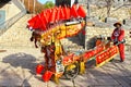 Beijing, China, November 28, 2019: Retailer or vendor wearing a traditional Chinese suit. Sign indicating to take a rickshaw to