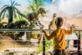 Beijing China, October 16, 2018: Boy in a yellow jacket watching dinosaur in museum