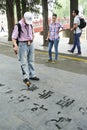 Writing Chinese calligraphy on the ground