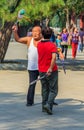 Elder couple playing Chinese game of Jianzi with a colorful feat