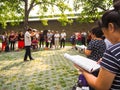 Group of middle aged and retired people singing in the park