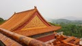 Beijing-A close up on the rooftop of a pavilion in Summer Palace in China. The roof has orange tiles and decorative small figures Royalty Free Stock Photo