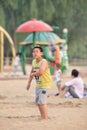 Young overweight Chinese boy on a beach, Beijing, China