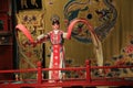 Beijing Opera, on the stage a female warrior dances in a bright traditional suit.