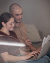 Being an adult means paying bills. Shot of a young couple paying bills together using a laptop. Royalty Free Stock Photo