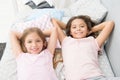 Being as happy as the day is long. Happy little girls having afternoon nap in bedroom. Adorable small children relaxing Royalty Free Stock Photo