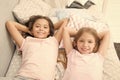 Being as happy as the day is long. Happy little girls having afternoon nap in bedroom. Adorable small children relaxing Royalty Free Stock Photo