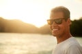 Being at the beach is my thing. Portrait of a handsome young man standing on the beach at sunset.