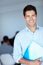 Being in business never felt this good. A shot of a smiling young man holding a document at work.