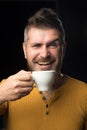 Being in coffee mood. Happy hipster drinking coffee in the morning. Bearded man smiling with coffee cup for breakfast Royalty Free Stock Photo