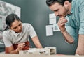 Being a designer means being a problem solver. two architects working together on a scale model of a building in an Royalty Free Stock Photo