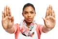 Being firm and saying no. Pretty yougn woman gesturing STOP against a white background.