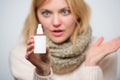 Being good for sinus health. Nasal spray for sick girl with runny nose. Cute woman nursing nasal cold or allergy Royalty Free Stock Photo