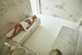 Beautiful lady turning her head while lying on the towel Royalty Free Stock Photo