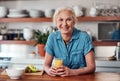 Being healthy makes me happy. Cropped portrait of an attractive senior woman enjoying a glass of orange juice while Royalty Free Stock Photo