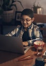 Being homeschooled has never made him happier. an adorable little boy using a laptop while completing a school Royalty Free Stock Photo