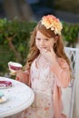 Being a lady...A red headed little girl dressed up and having a tea party in her garden. Royalty Free Stock Photo