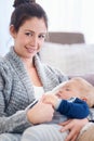 Being a mother is one of lifes greatest treasures. Portrait of a mother holding her sleepy baby boy at home. Royalty Free Stock Photo