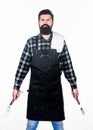 Being ready for bbq party. Grill cook holding spatula and bbq fork. Bearded man with bbq tools in hands. Happy hipster